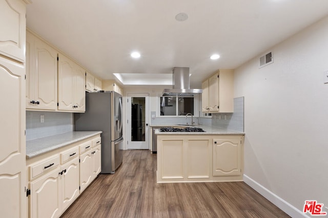 kitchen featuring stainless steel refrigerator with ice dispenser, dark wood-type flooring, tasteful backsplash, island range hood, and cream cabinets