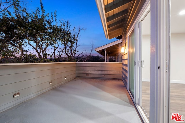 view of balcony at dusk