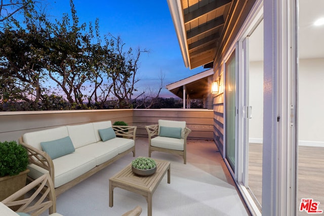 balcony at dusk with outdoor lounge area