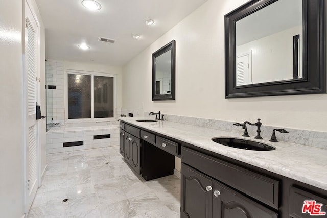 bathroom with vanity and a bathtub