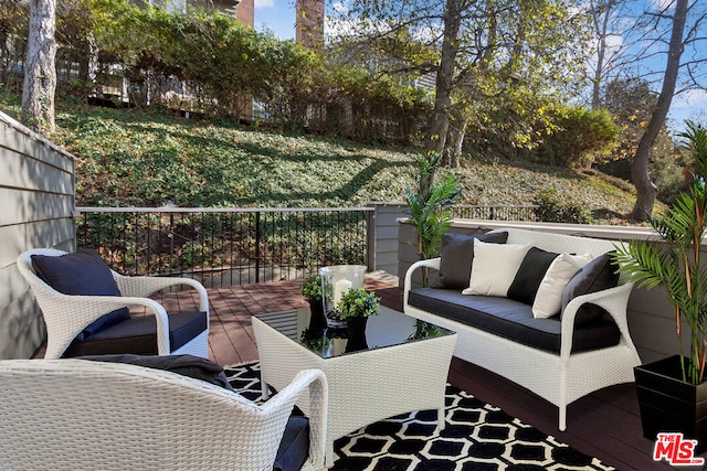 wooden terrace featuring outdoor lounge area