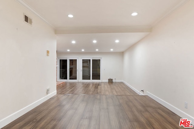 empty room with hardwood / wood-style floors and ornamental molding