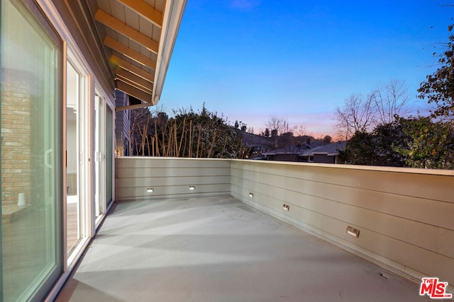 view of balcony at dusk