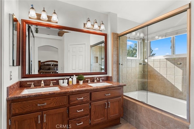 bathroom featuring shower / bath combination with glass door and vanity