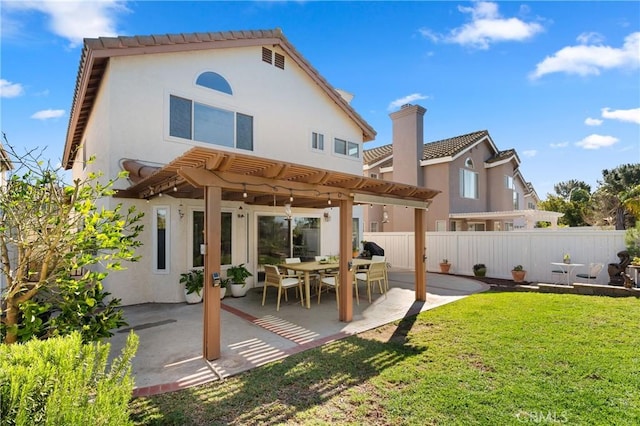 back of property featuring a pergola, a patio area, and a yard