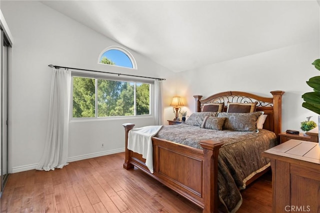 bedroom with dark hardwood / wood-style flooring and vaulted ceiling