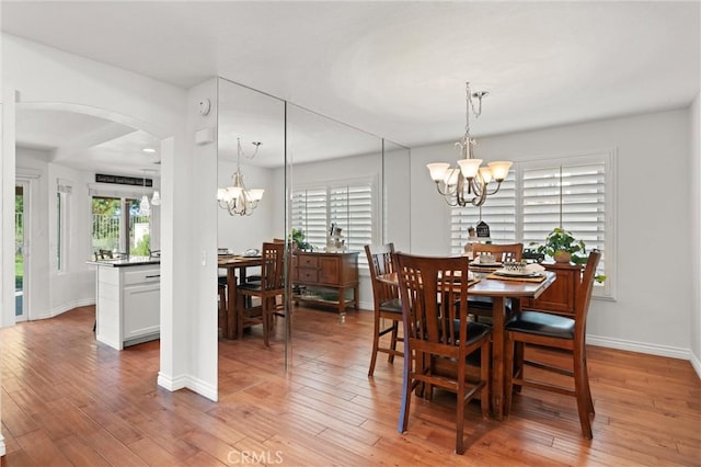 dining room with a notable chandelier and hardwood / wood-style flooring