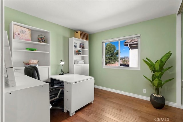 home office with washer and clothes dryer and hardwood / wood-style flooring