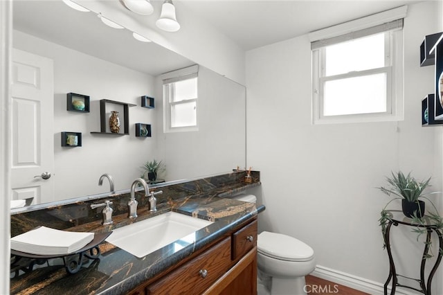 bathroom with toilet and vanity