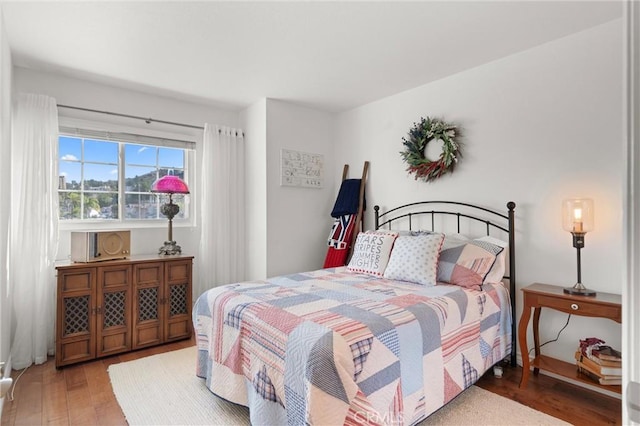 bedroom with hardwood / wood-style floors