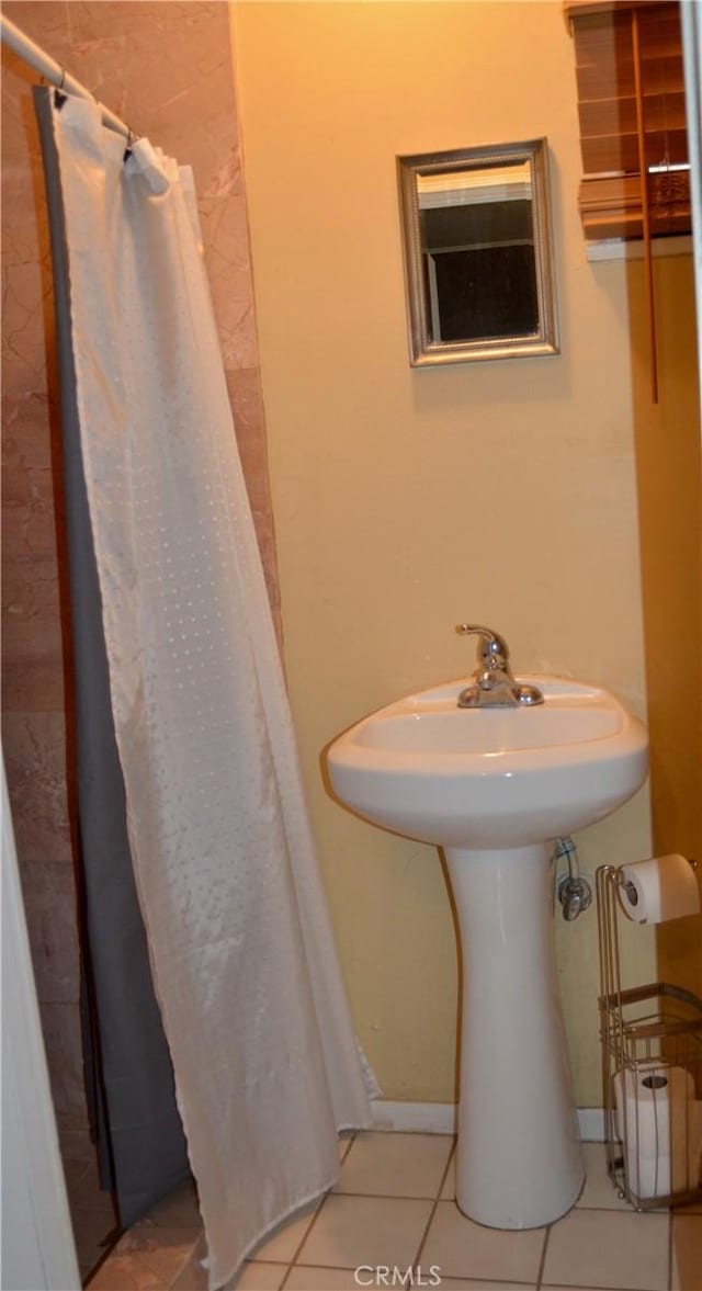 bathroom featuring a shower with curtain and tile patterned flooring