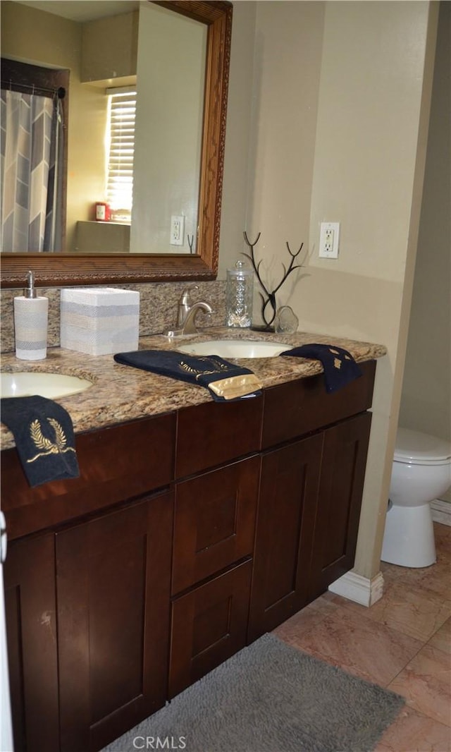 bathroom with toilet and vanity