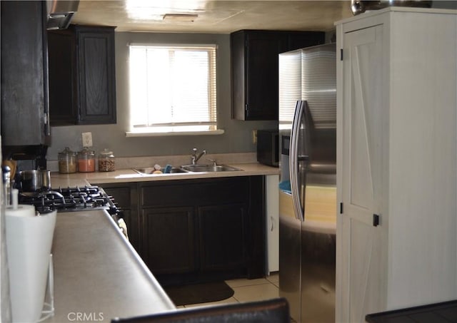 kitchen with sink, stainless steel appliances, and light tile patterned flooring