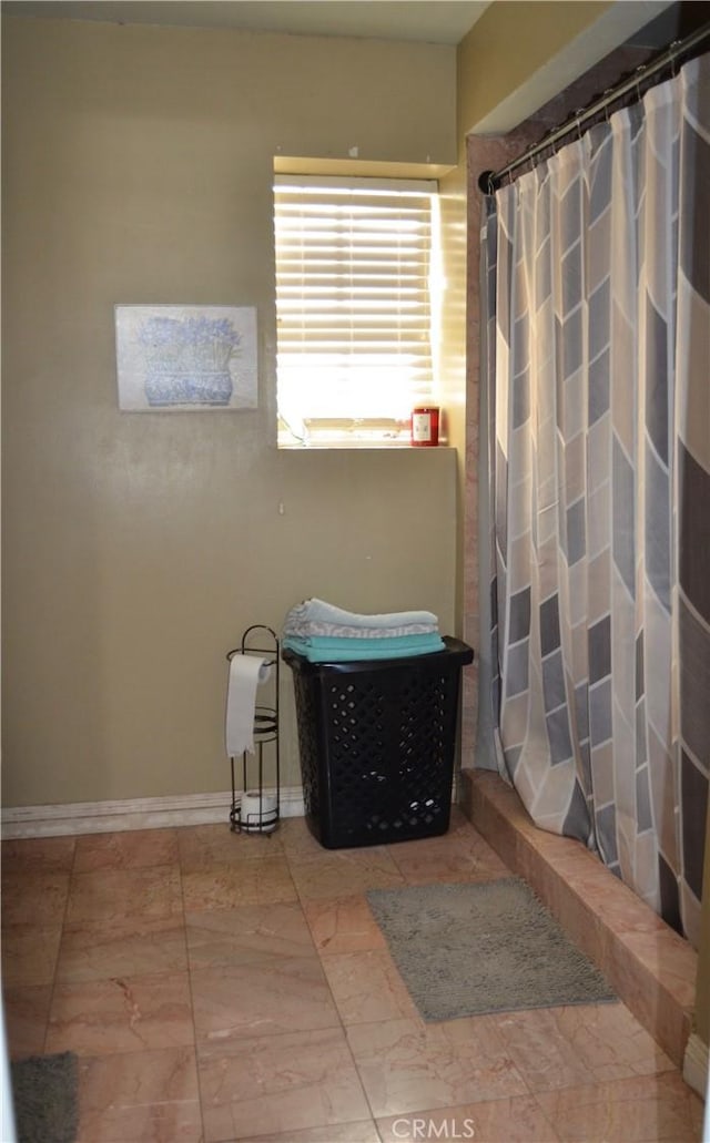 bathroom with tile patterned floors and a shower with shower curtain