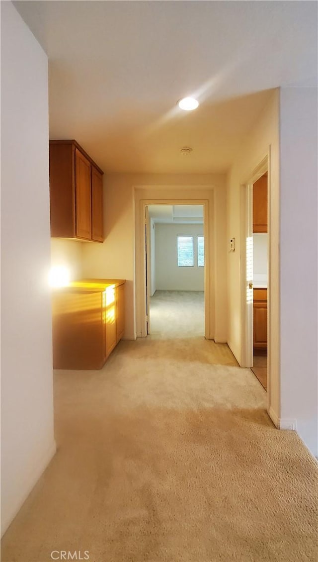 hallway with light colored carpet