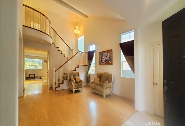 sitting room with wood-type flooring and a high ceiling