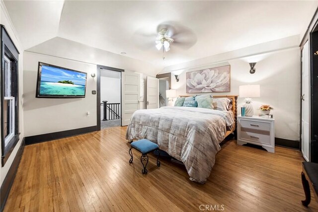 bedroom featuring vaulted ceiling, ceiling fan, and wood-type flooring