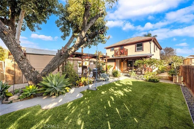 view of front of home with a front lawn and a balcony