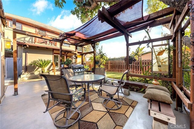 view of patio featuring grilling area and a pergola