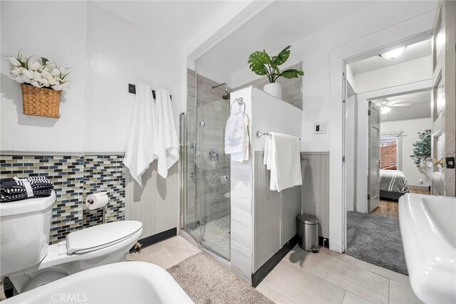 bathroom featuring toilet, ceiling fan, a bidet, tile patterned floors, and walk in shower