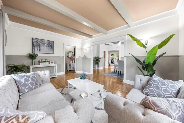 living room featuring light hardwood / wood-style floors and beam ceiling