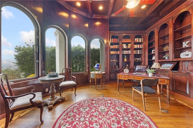 sitting room with beamed ceiling, plenty of natural light, coffered ceiling, and built in shelves