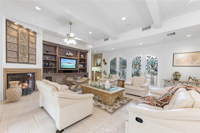 living room featuring beam ceiling, built in shelves, and ceiling fan