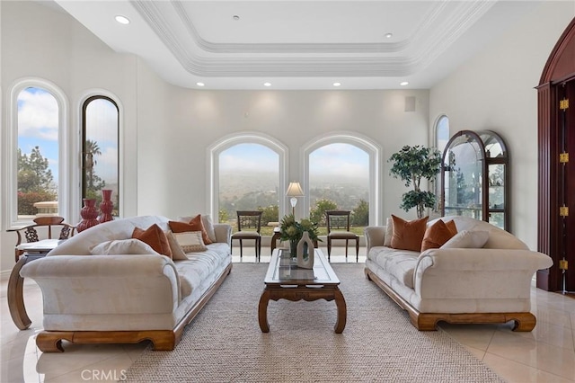 tiled living room featuring a wealth of natural light and a tray ceiling