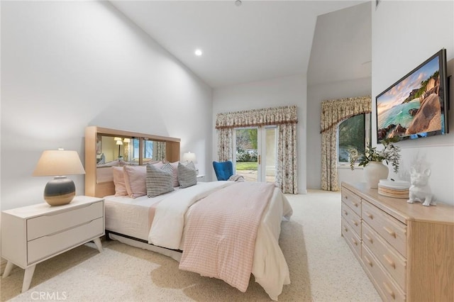 bedroom with light colored carpet and a high ceiling