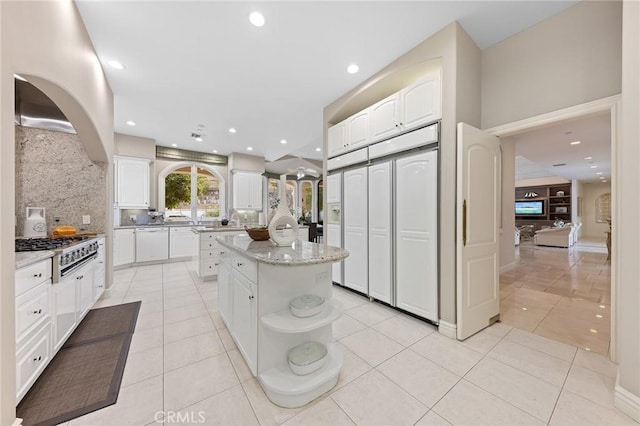 kitchen featuring light tile patterned floors, a kitchen island, and stovetop