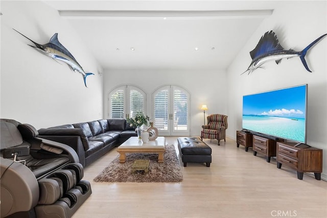 living room with lofted ceiling with beams, french doors, and light hardwood / wood-style floors