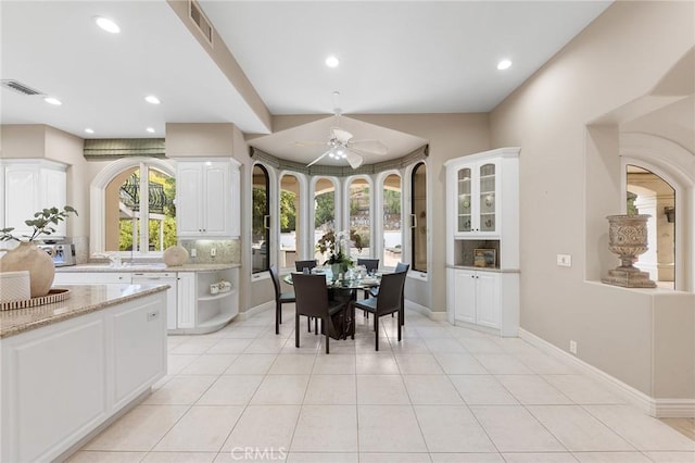 dining area with ceiling fan and light tile patterned floors