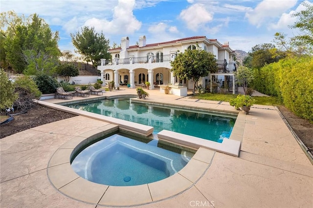 view of swimming pool with a patio and an in ground hot tub