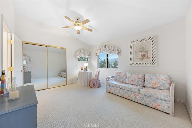 living room featuring vaulted ceiling, ceiling fan, and carpet flooring