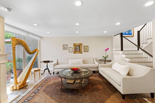 living room featuring wood-type flooring and floor to ceiling windows