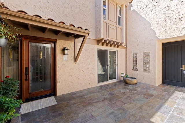 property entrance with a patio