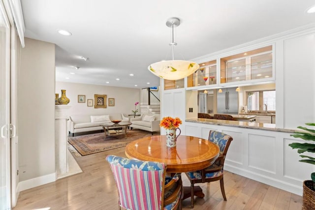 dining area featuring sink and light hardwood / wood-style flooring