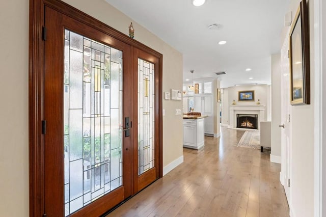 foyer entrance featuring french doors and light wood-type flooring