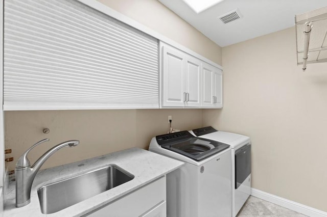 laundry room featuring cabinets, washer and clothes dryer, and sink