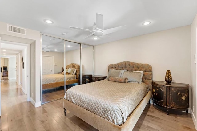 bedroom with a closet, ceiling fan, and light wood-type flooring