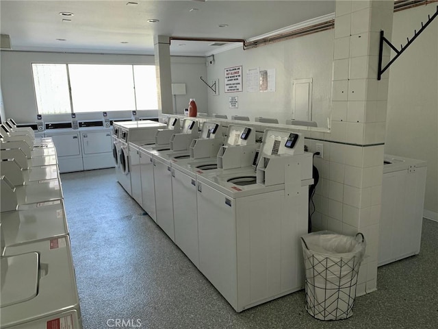 clothes washing area with washing machine and clothes dryer