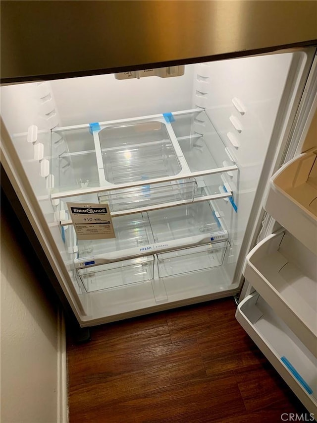 room details featuring fridge and dark hardwood / wood-style floors