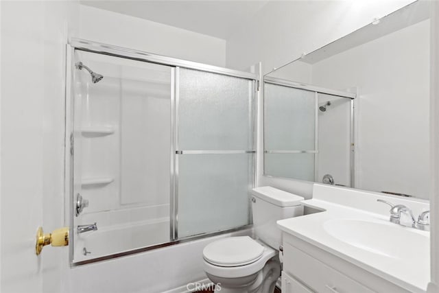 full bathroom with toilet, vanity, and bath / shower combo with glass door