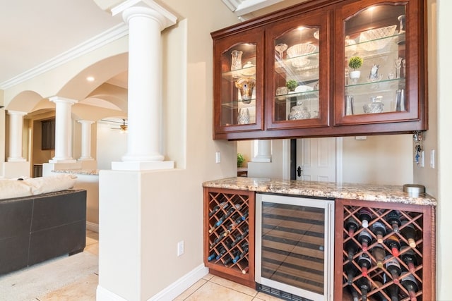 19490 Calle Juanito, Murrieta, CA 92562 - indoor dry bar featuring wine cooler, decorative columns, crown molding, light tile patterned flooring, and arched walkways