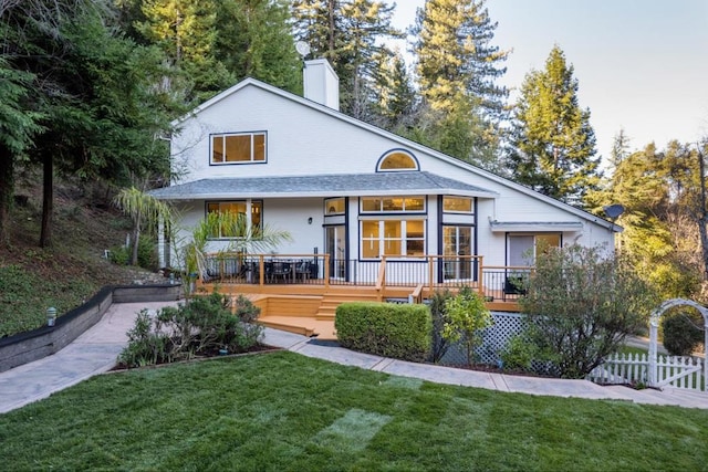 rear view of house with a yard