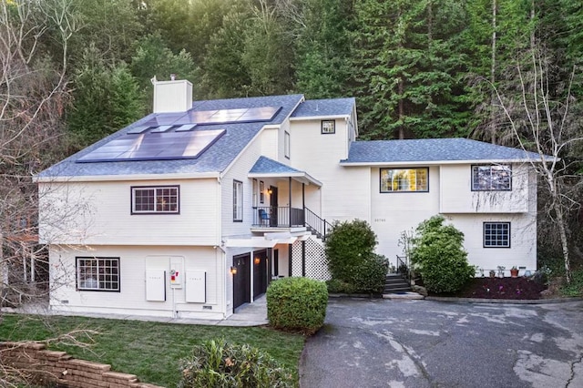 view of front of house featuring a garage and solar panels