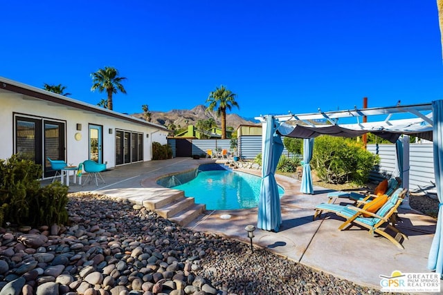 view of pool with a pergola and a patio