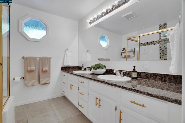 bathroom featuring tile patterned flooring, an enclosed shower, and vanity