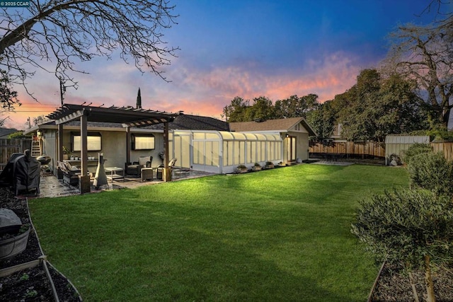 yard at dusk with a shed, a patio, and a pergola