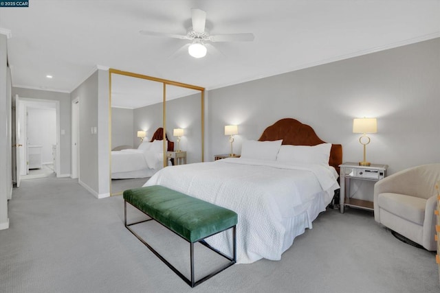 carpeted bedroom featuring ceiling fan, a closet, and crown molding